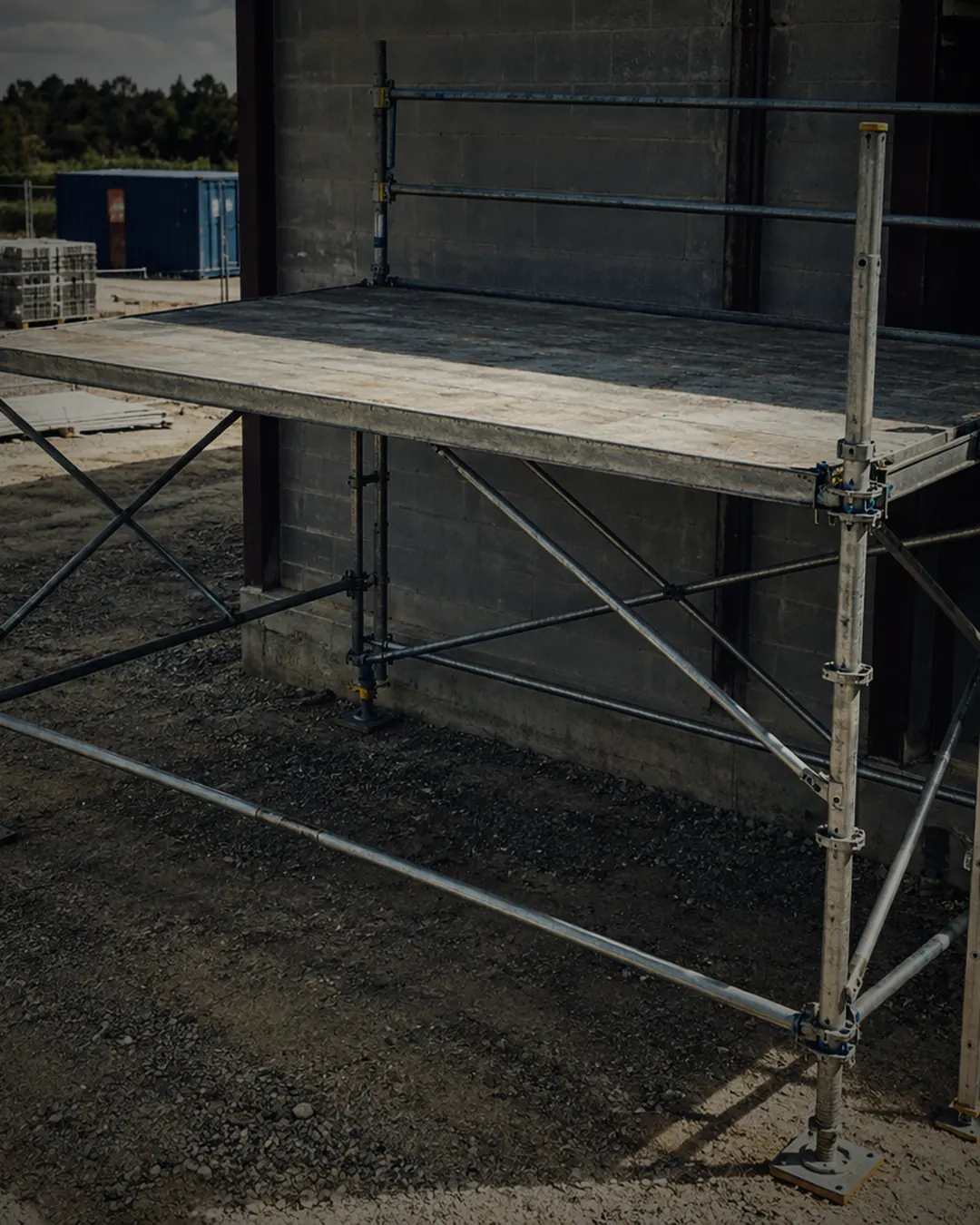 A scaffold platform on a construction site with its front edge open, no guardrail (illustrative AI-generated photograph).